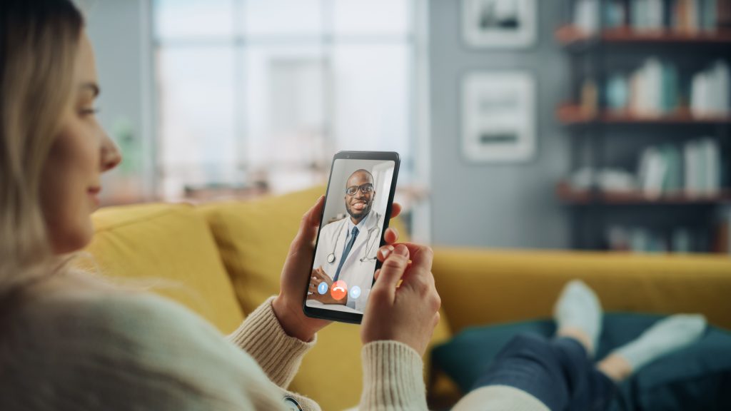 Close Up of a Woman Chatting in a Video Call with a Provider on Smartphone from Living Room.