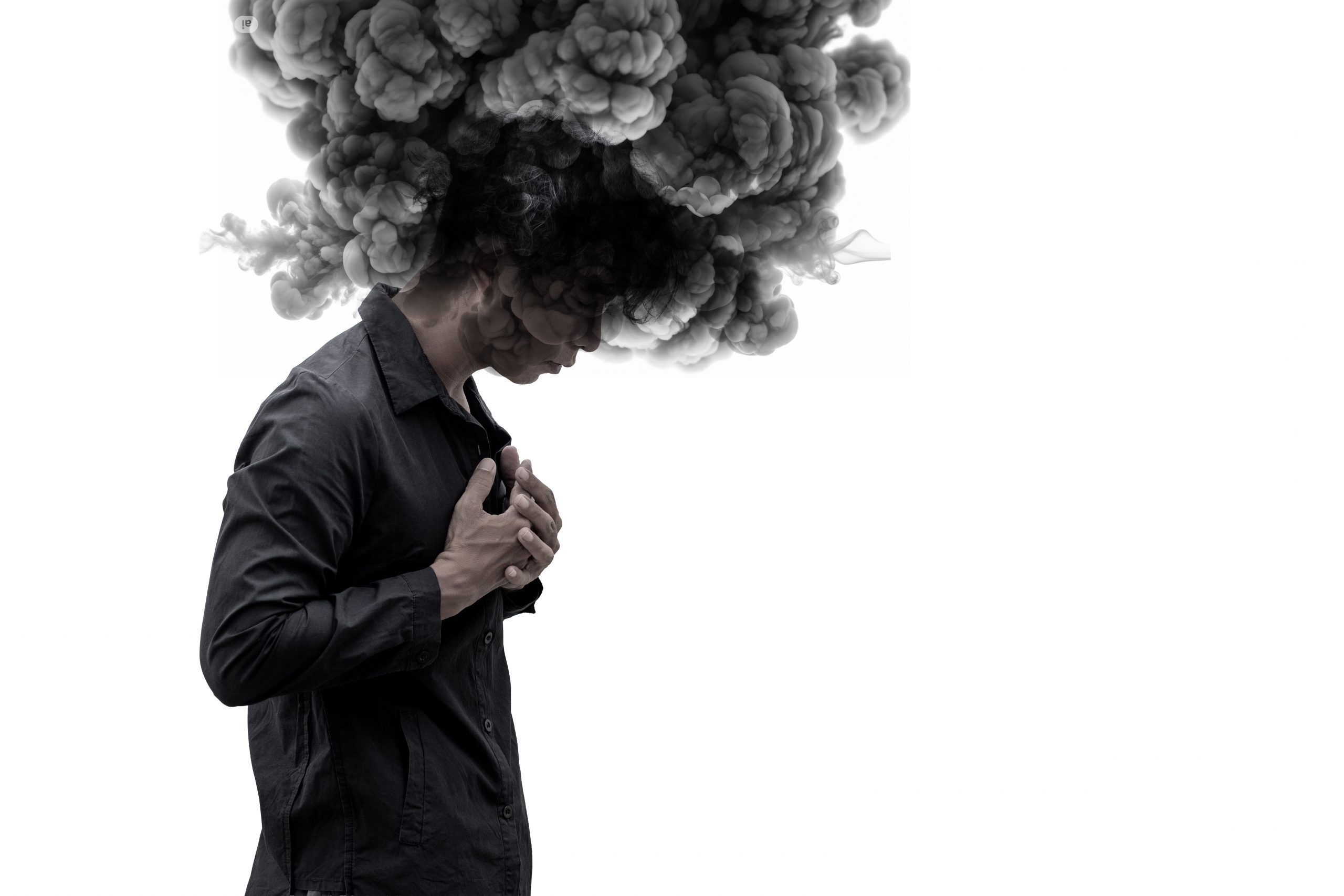 A person stands with their head bowed while a large cloud of dark smoke rises from their head, representing overthinking, emotional overwhelm, and intrusive negative beliefs.