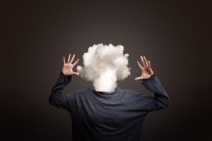 Conceptual image of a woman’s head as a cloud, representing mental fog and unclear thoughts associated with burnout. 