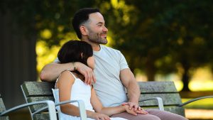 Father sitting with his young daughter on a park bench, illustrating how building a healthier relationship with yourself can strengthen the relationships that matter most.