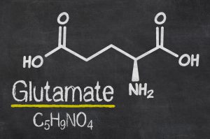 Chemical structure and molecular formula of glutamate written on a blackboard. 